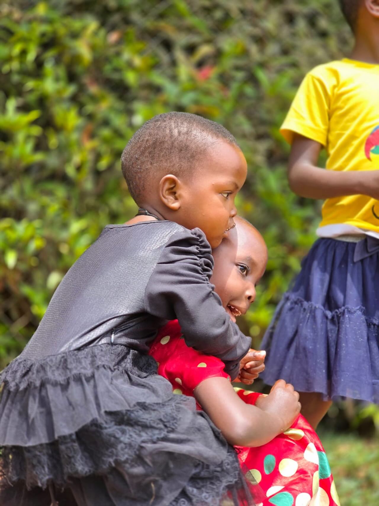 Two children hug