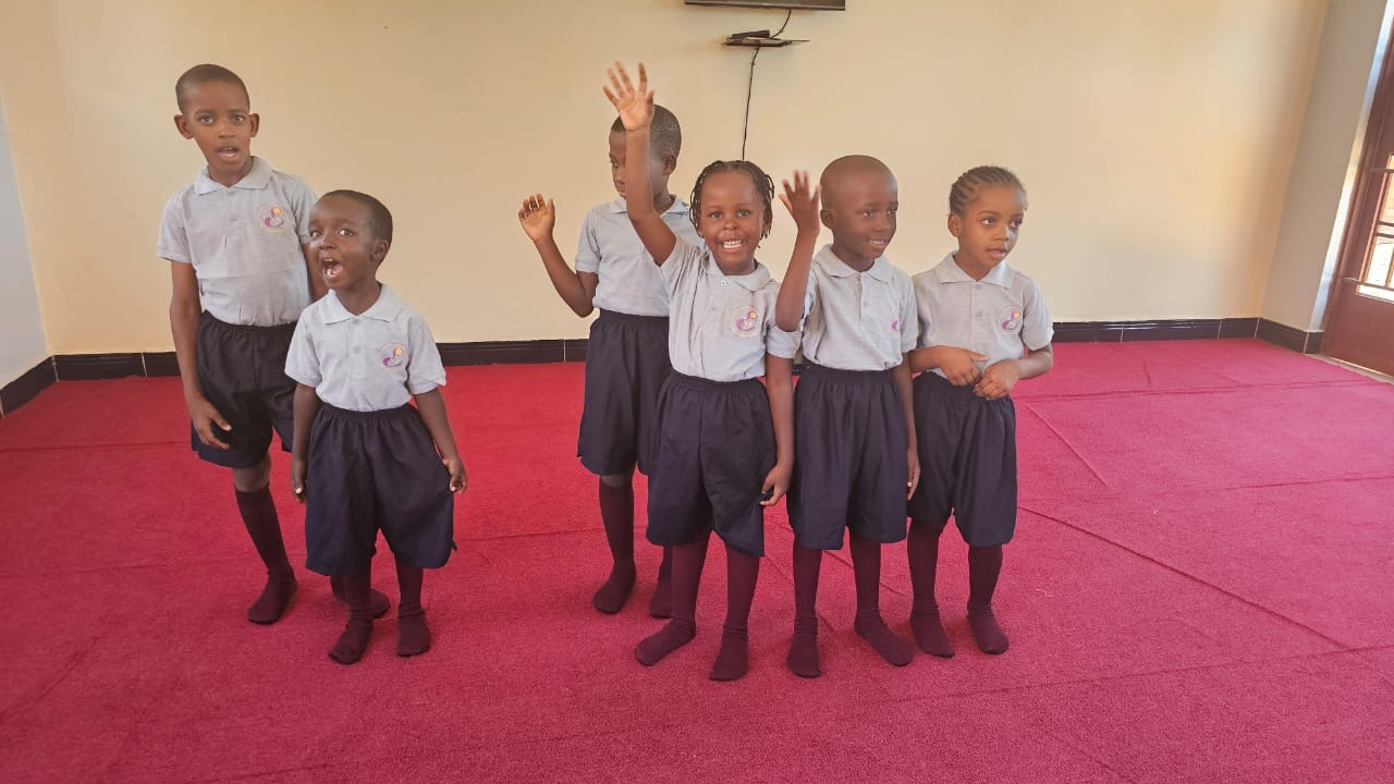 Children in school uniforms waving